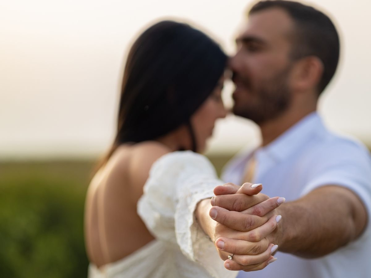 Couple holding hands closely, expressing emotional connection that supports Mutual Climax