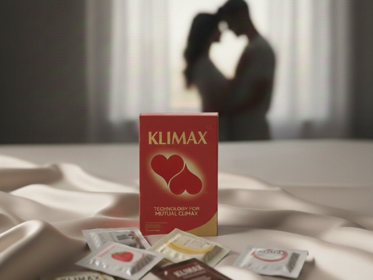 Klimax condom pack with flavored variants on a bed, inviting couples to Explore Premium Flavored Condoms